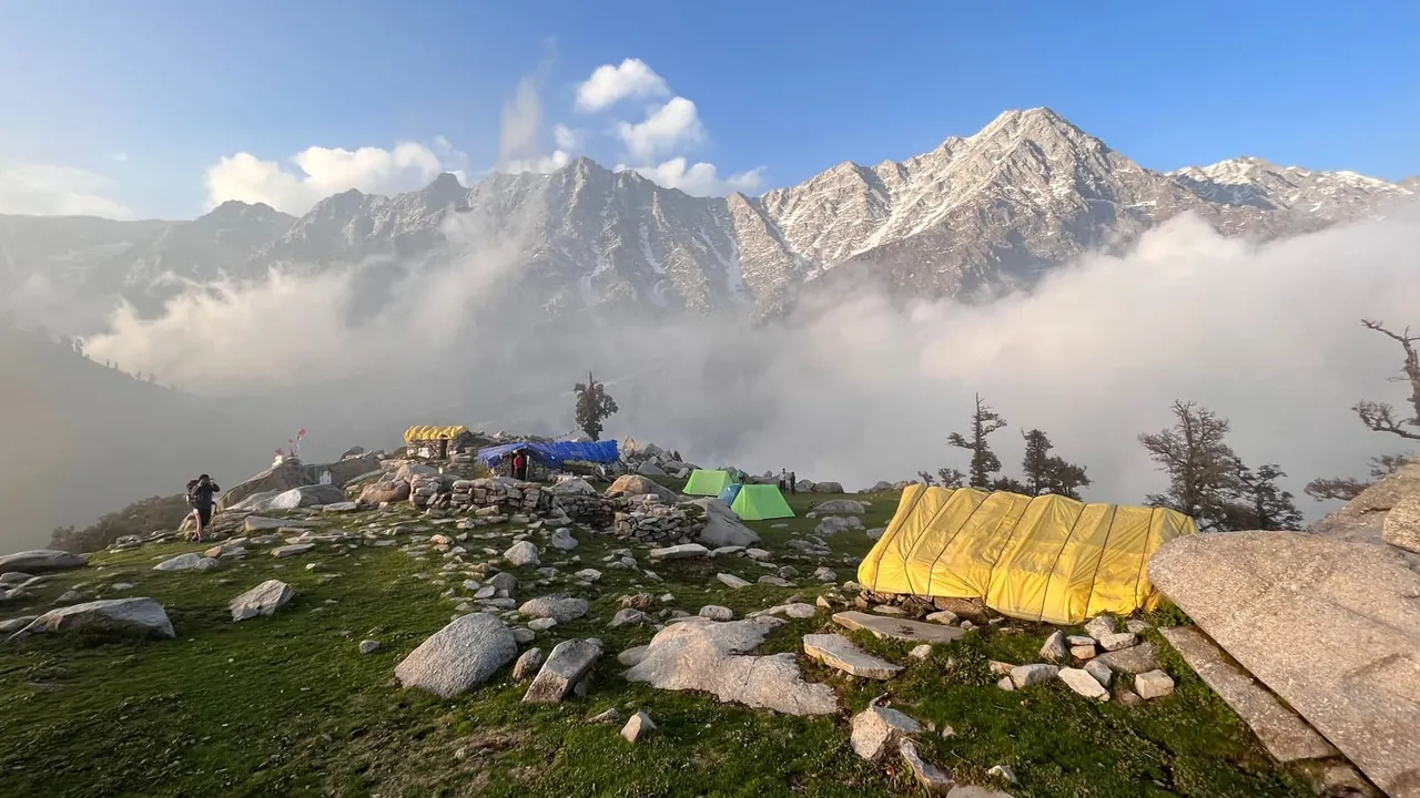 A mountain campsite at dawn, tents nestled among the peaks